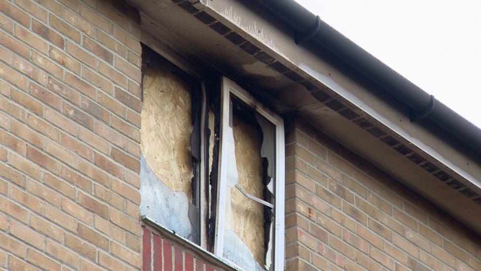 A broken window has been boarded up at the site.