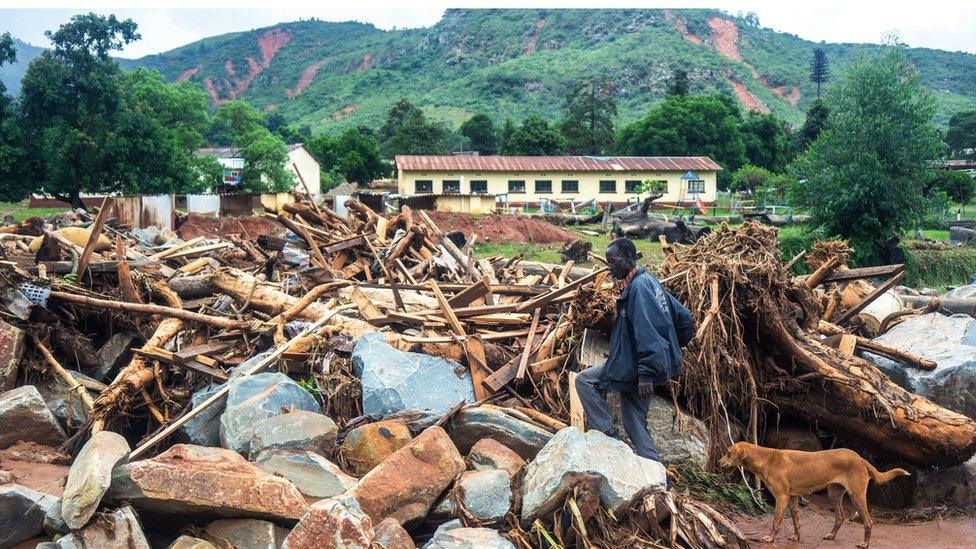 A man searches the rubble for missing family members