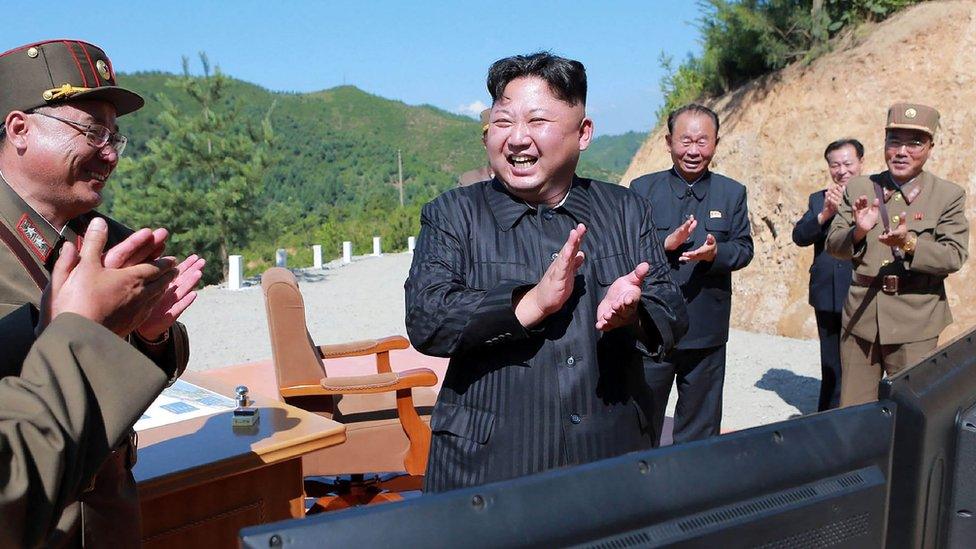 This picture taken on 4 July, 2017 shows North Korean leader Kim Jong-Un celebrating the successful test-fire of an intercontinental ballistic missile