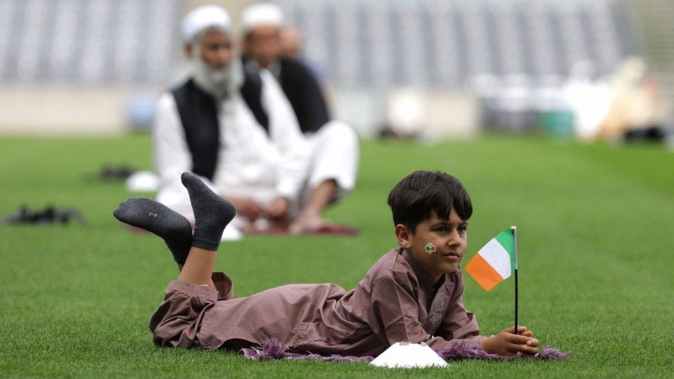 A six-year-old boy holds an Irish flag during the Eid celebration in Croke Park