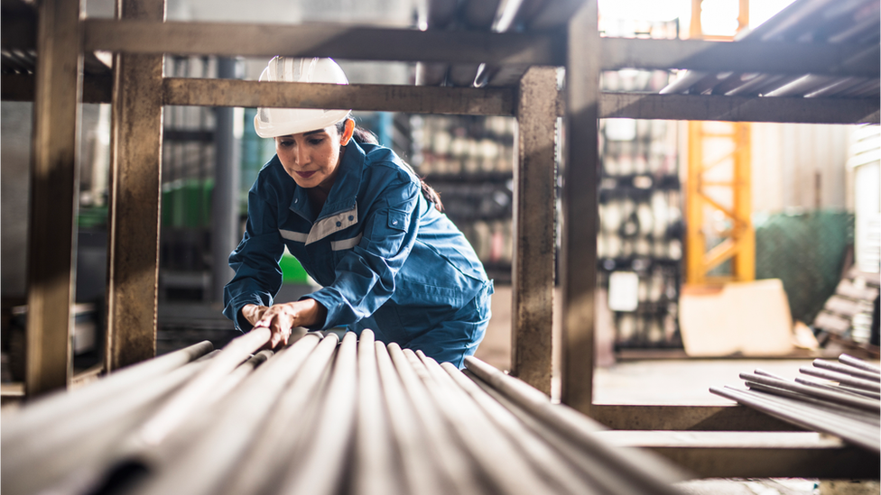 Woman working with pipes in store