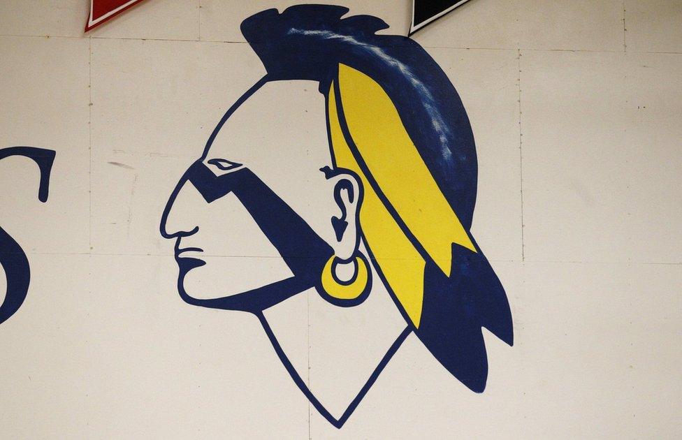 A Native American mascot painted on a wall