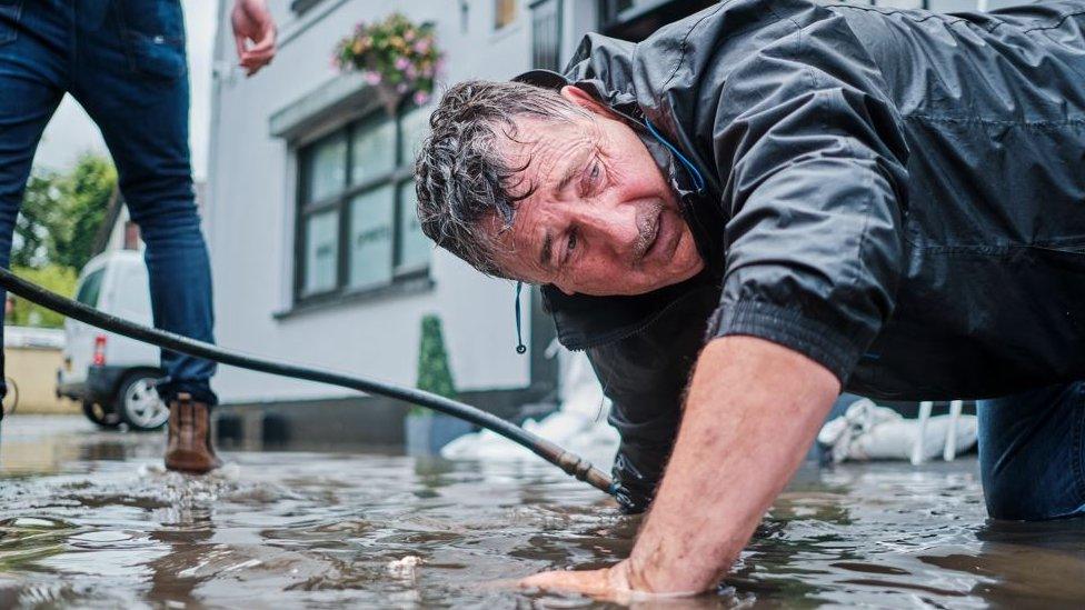 Pat Gillespie of Sion Mills Community Forum tries to find the cause of the flooding