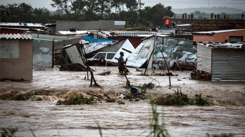 A Mamelodi resident wades through water in an area where 700 shacks were reportedly destroyed during heavy rains, Pretoria, South Africa, 09 December 2019