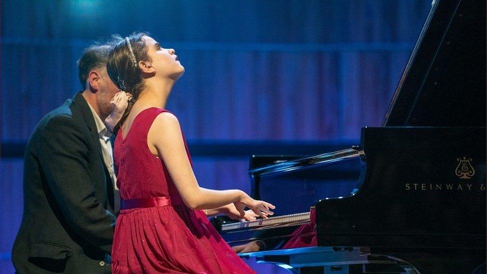 Lucy playing piano