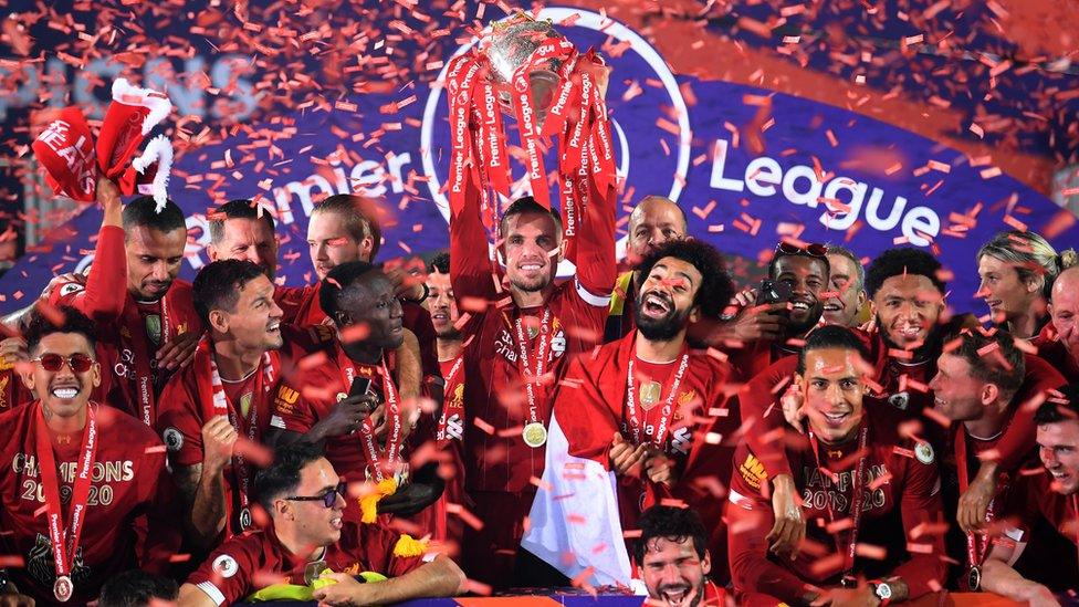 Klopp lifts the Premier League trophy.