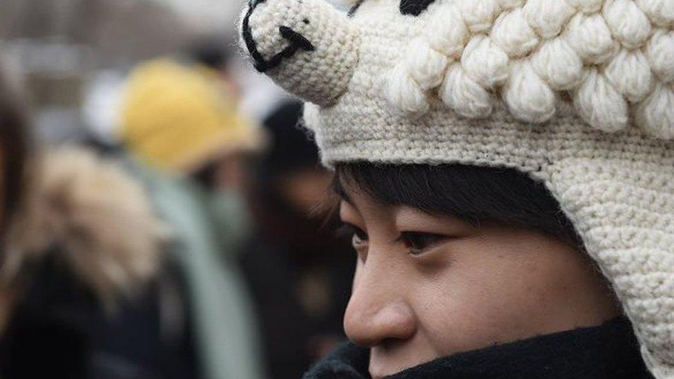 A Chinese lesbian, who goes by the pseudonym Qiu Bai, speaks to the media before entering the Beijing No.1 Intermediate People's Court in Beijing on November 24, 2015.