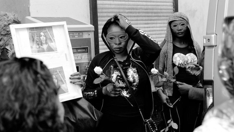 Women in masks protest the death of Eunice Osayande