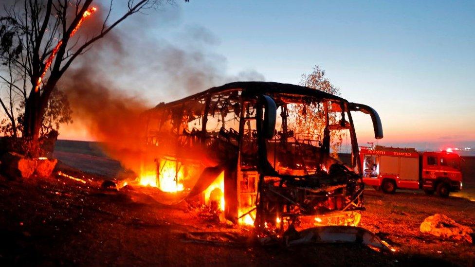 A bus set ablaze after it was hit by a rocket fired from the Gaza Strip, 12 November 2018