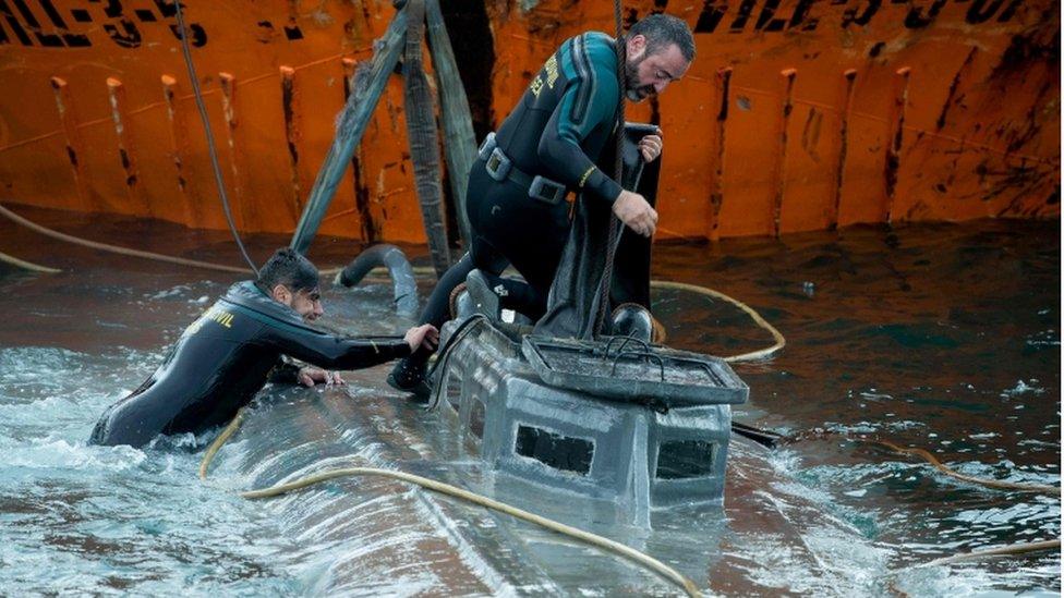 Guardia Civil divers inspect the suspected narco-submarine in Aldán, Galicia