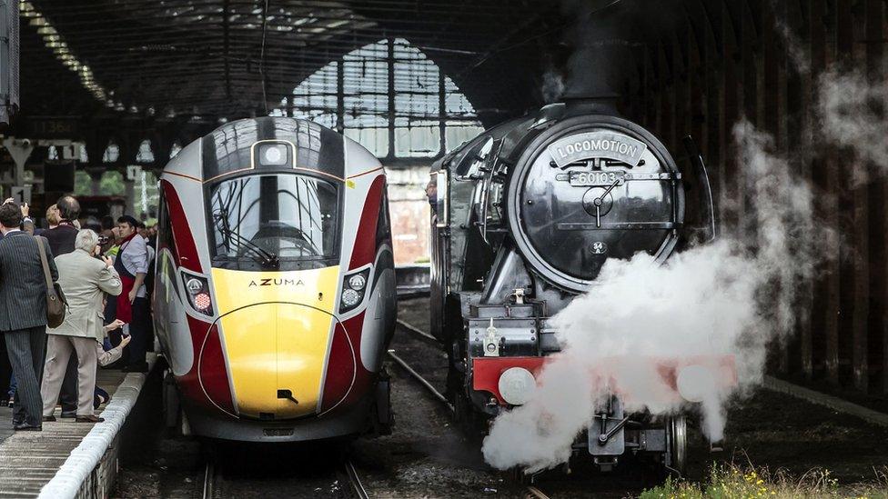 Flying Scotsman steam locomotive standing next to Azuma train