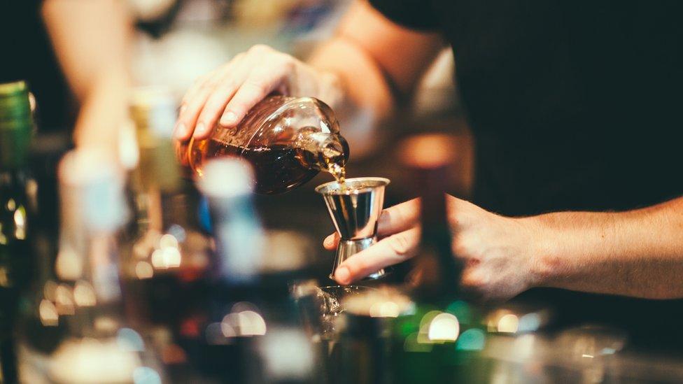 Barman preparing cocktail - stock photo