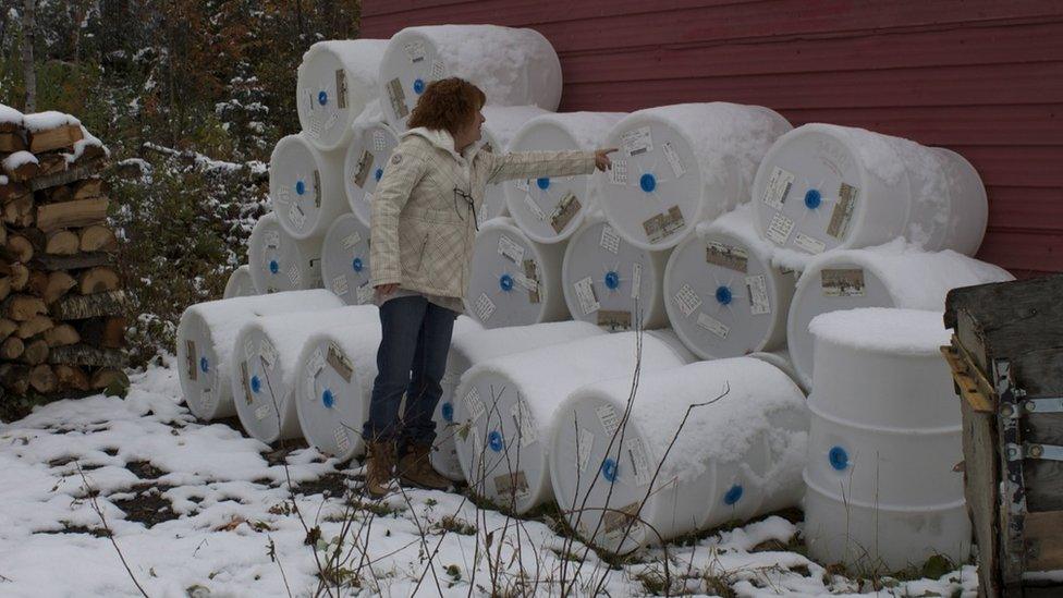 Angele Grenier checking barrels of her maple syrup