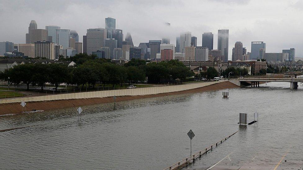 The US city of Houston in Texas has been battered by the biggest storm in its history, which has turned roads into rivers.