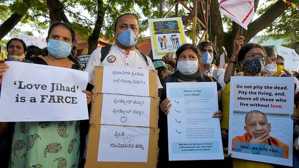 Activists belonging to various human and civil rights organisations hold placards during a demonstration condemning the decision of various Bharatiya Janata Party (BJP) led state governments in the country for the proposed passing of laws against "Love Jihad"