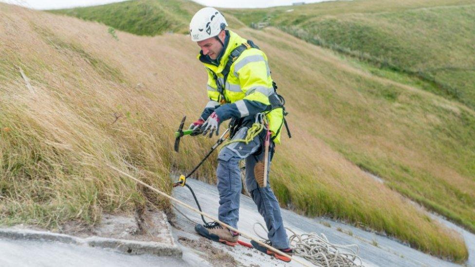 Volunteer abseiling down White Horse