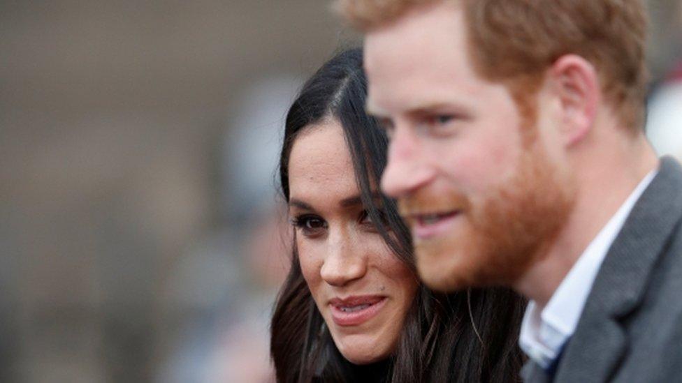 Meghan Markle, and Britain"s Prince Harry, meet members of the crowd as they arrive for a visit to Edinburgh