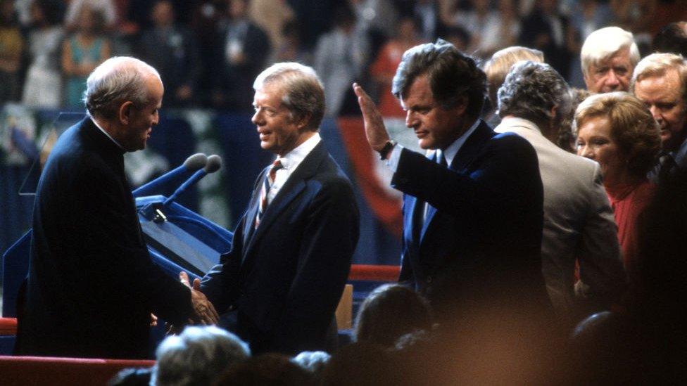 President Jimmy Carter is congratulated by Senator Robert Drinan and Presidential candidate Senator Ted Kennedy after giving a speech at the Democratic National Convention in 1980