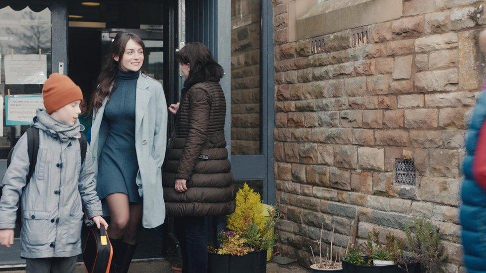 Scene showing Amelia and Louie walking out of a school