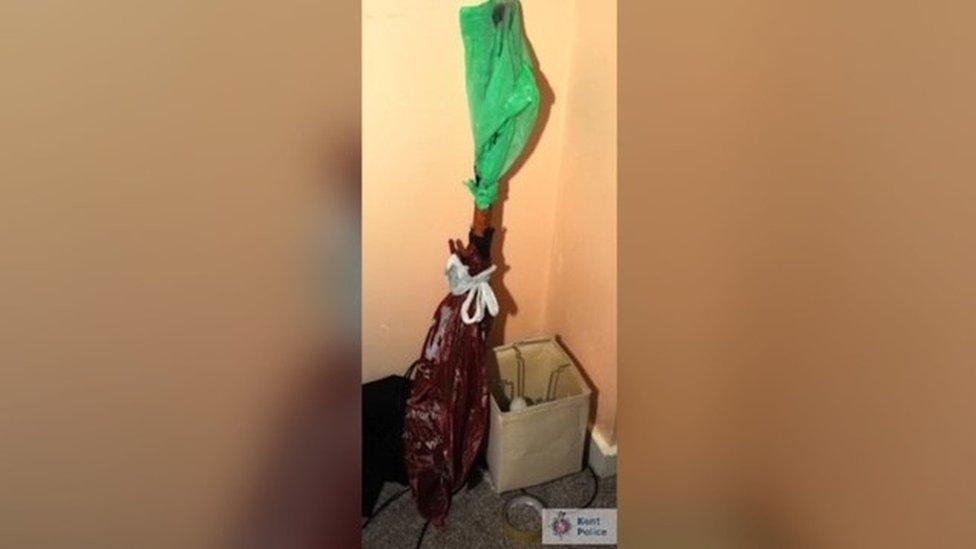 Police evidence image of a long object wrapped in plastic bags