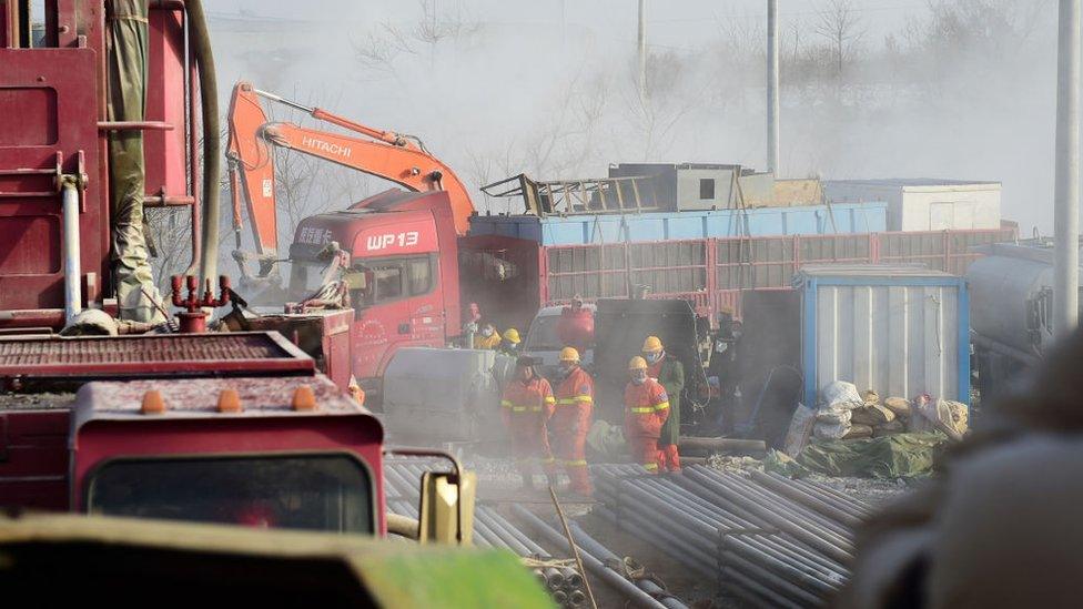 This photo taken on January 13, 2021 shows rescuers working at the site of gold mine explosion where 22 miners were trapped underground in Qixia, in eastern China's Shandong province.