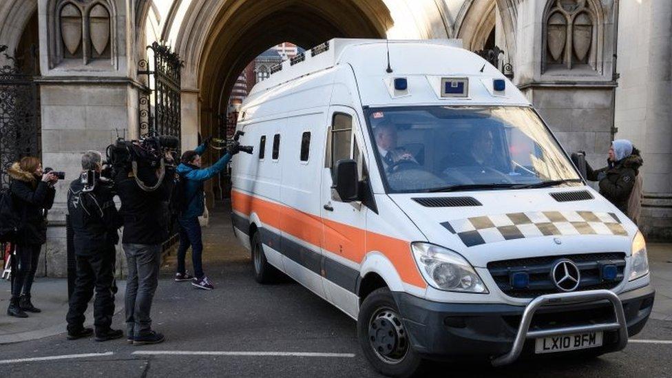 Members of the media look on as a prison van carries convicted rapist John Worboys from the High Court