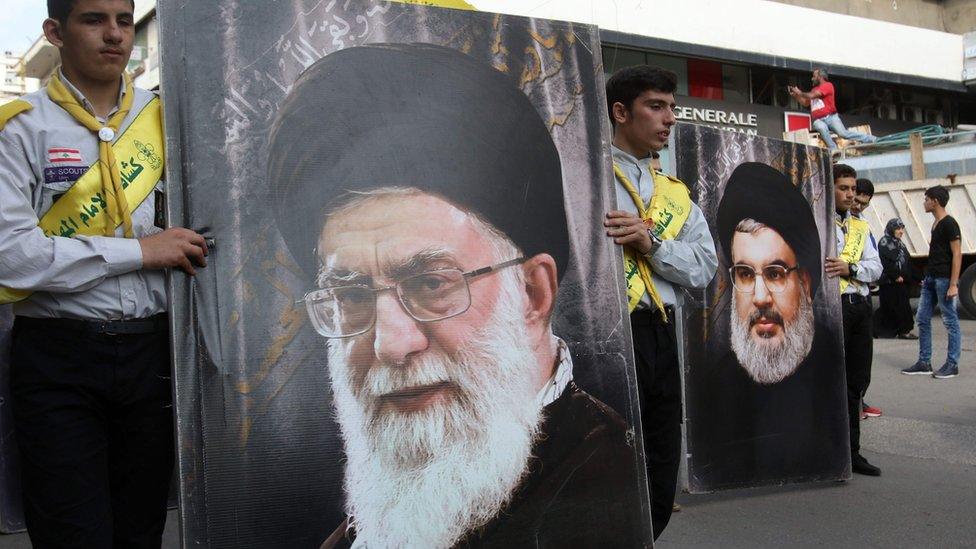 Hezbollah supporters carrying posters Iran's Supreme Leader Ayatollah Ali Khamenei and Hezbollah leader Hassan Nasrallah in the southern Lebanese city of Nabatieh (8 November 2017)