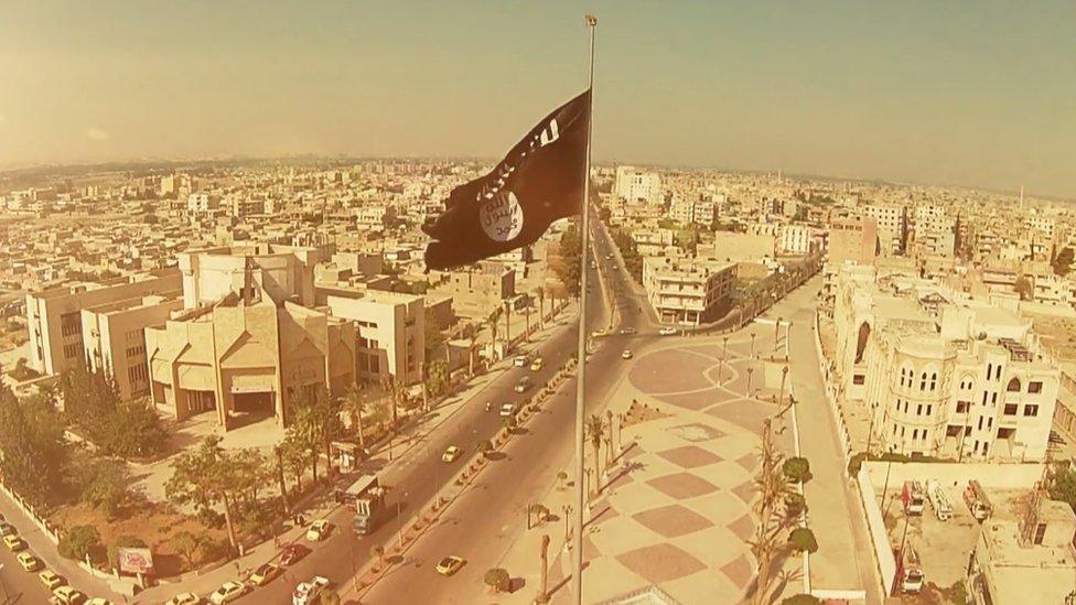 Screengrab of IS propaganda showing unidentified city with IS flag flying over it.