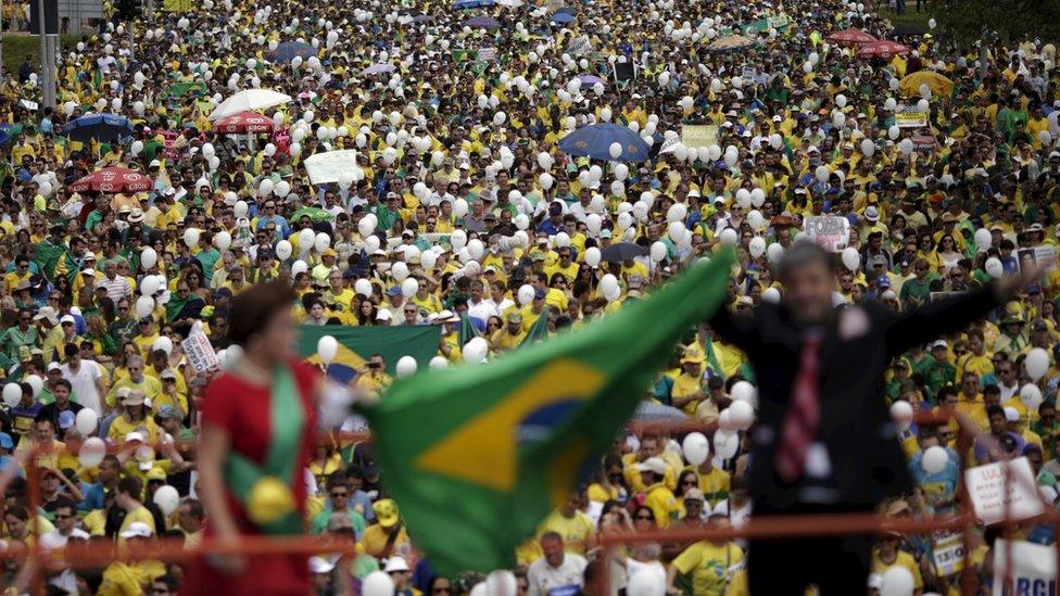 Protesters marched through the streets of cities across Brazil, many wearing the colours of the national football team and carrying the country's flag