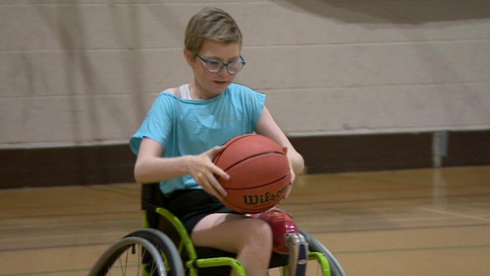 Picture of Mia playing wheelchair basketball