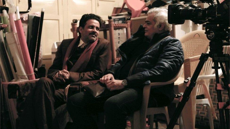 Indian filmmaker Hansal Mehta (R) speaks with actor Manoj Bajpayee on set during the production of "Aligarh" at Bareilly in the northern Indian state of Uttar Pradesh.