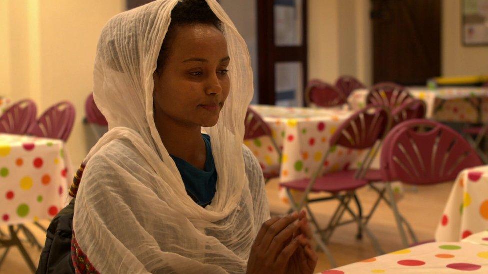 Still from the Lord's Prayer advert showing woman praying