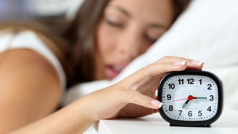 Woman with alarm clock