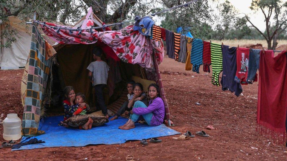 Displaced Syrian children in a field near a camp in Atmeh, Idlib province, Syria (23 May 2019)