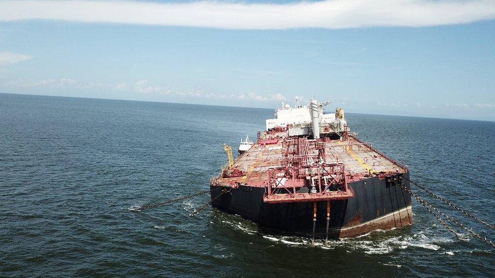 oil tanker at an angle in the ocean.