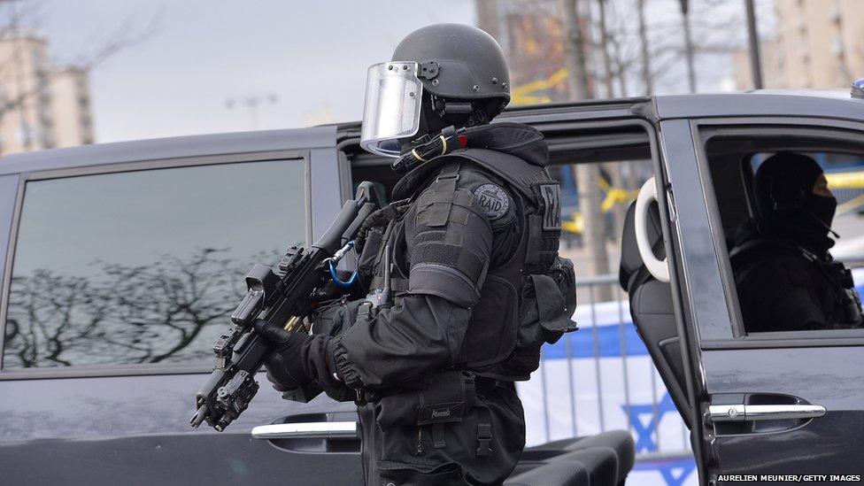 French police elite RAID secures the area while Benjamin Netanyahu, Prime Minister of Israel , pays his respects at the Hyper Cacher following the recent terrorist attacks on January 12, 2015 in Paris, France