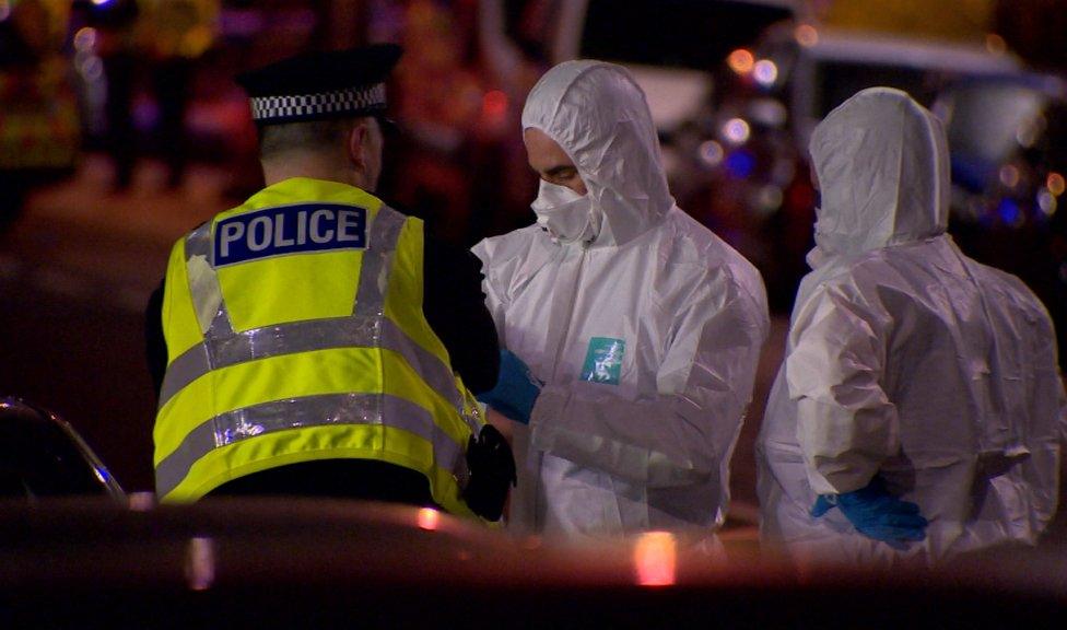 Uniformed officers and forensic specialists worked through the night