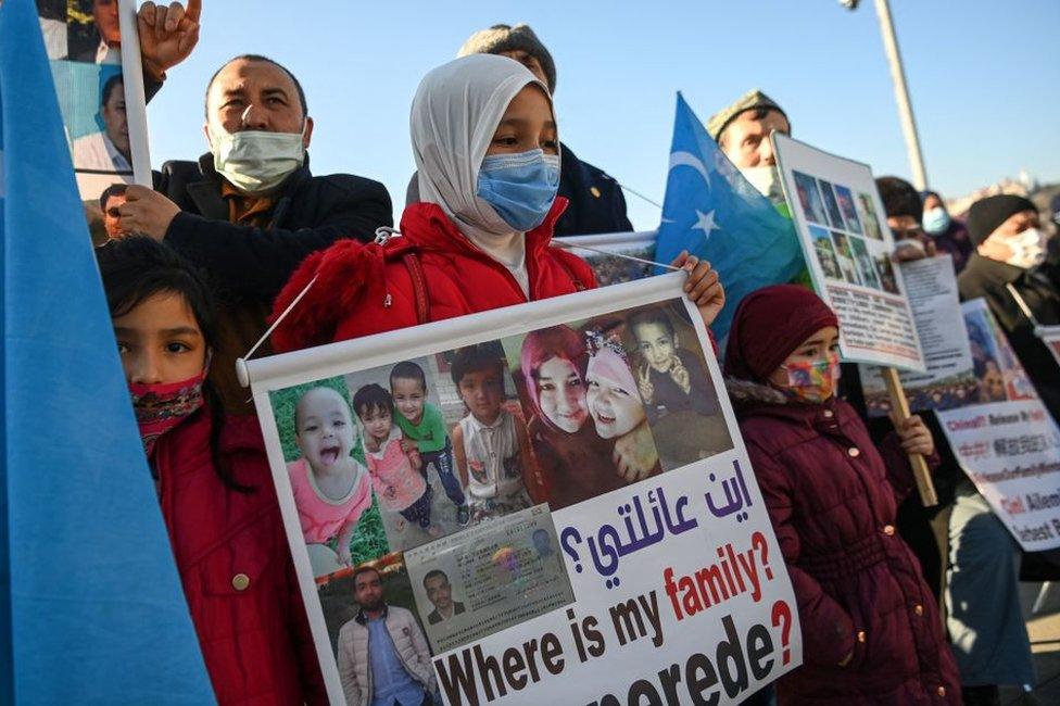 Members of Uighur minority hold placards as they demonstrate on February 22, 2021 near China consulate in Istanbul