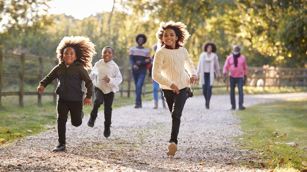 GIRLS-RUNNING-OUTSIDE-LEAVES.