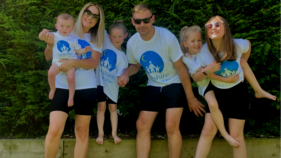 Abby Lever and Jamie Davey with their children whilst in the garden.