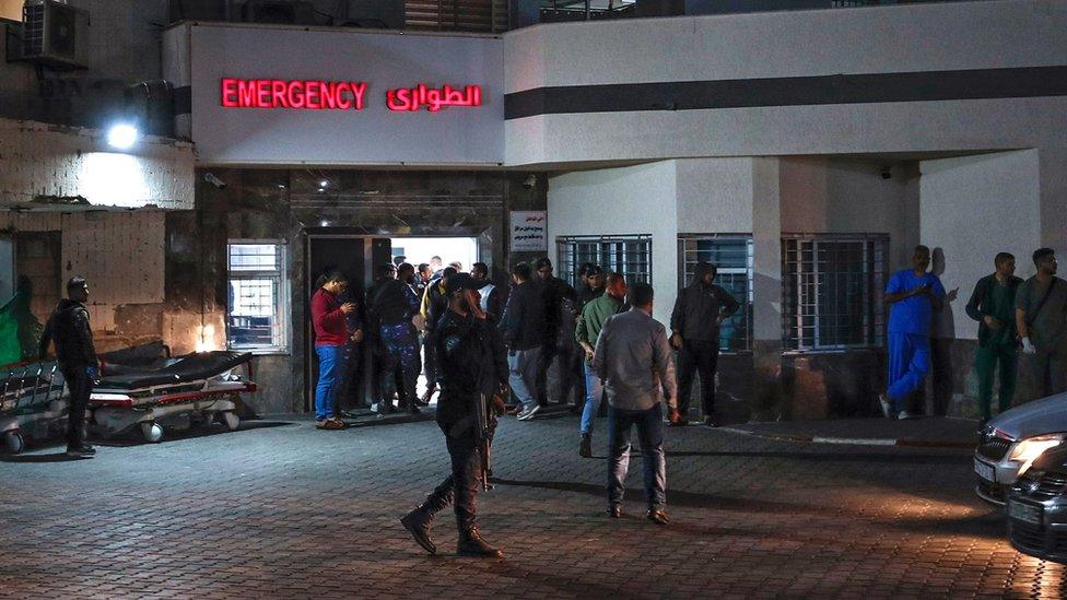 People gather outside the Al-Shifa hospital in Gaza where transplant doctor Hammad was meant to be operating