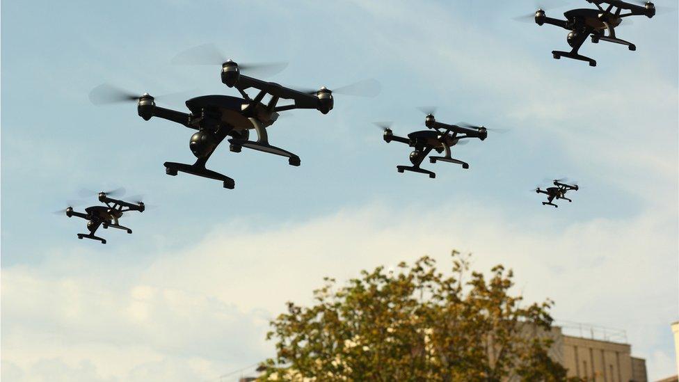 Drones flying above building