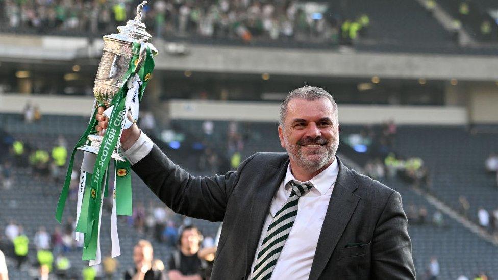 Manager Ange Postecoglou holding up trophy