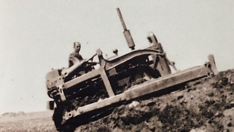 A bulldozer in use during the construction of the base