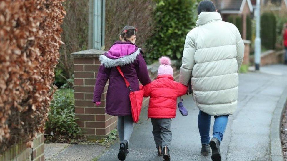 Schoolchildren make their way to primary school