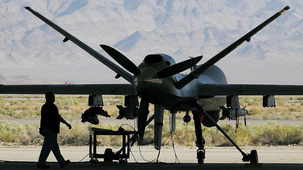 An engineer inspects an MQ-9 Reaper drone at Creech US Air Force Base