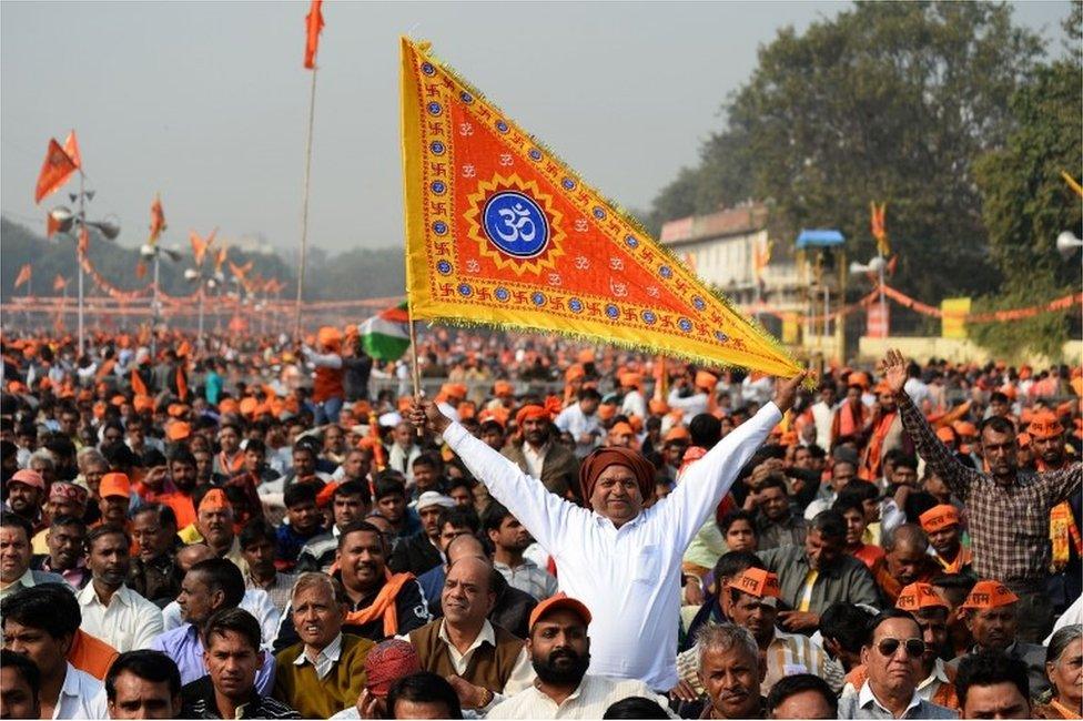 An Indian Hindu hardliner holds a religious flag as he participates in a rally calling for the construction of a temple on the site of the demolished 16th century Babri mosque, located in Ayodhya, in New Delhi on December 9, 2018.