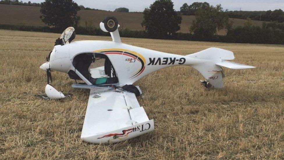 Aircraft upside down in field