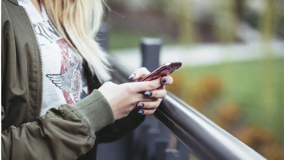 A person texting on a mobile phone