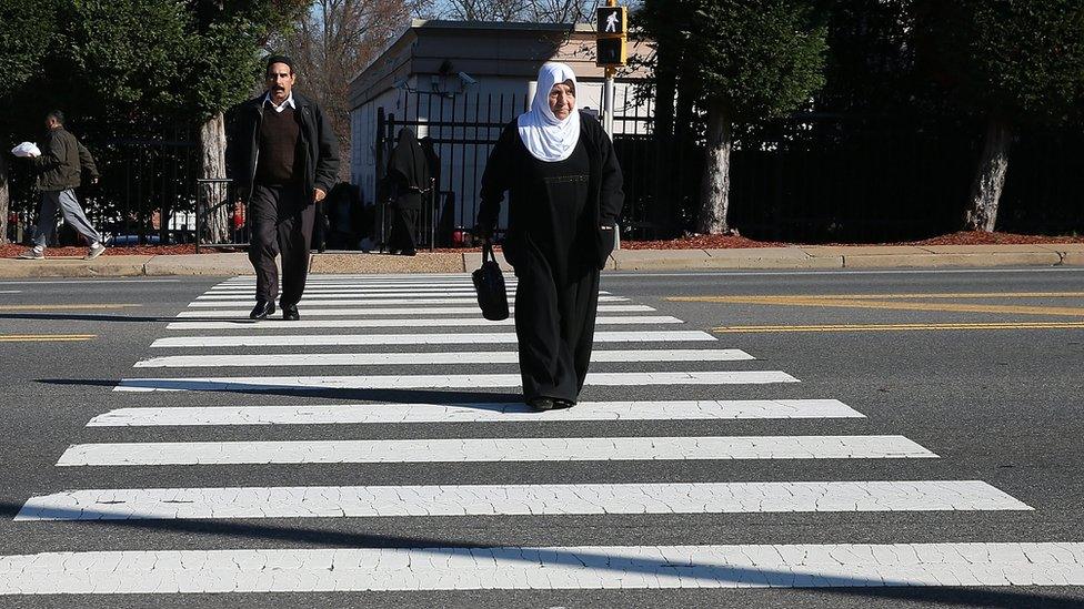 A women leaves Friday's prayers at the Dar Al-Hijrah Mosque, December 4, 2015 in Falls Church, Virginia. Members of Congress and media were invited to visit the Friday Prayers at the mosque two weeks after it was attacked with Molotov cocktails and a hoax bomb. (Photo by Mark Wilson/Getty Images)